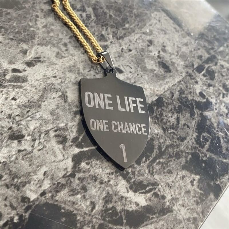 Pendentif bouclier noir gravé « One Life One Chance » sur chaîne dorée