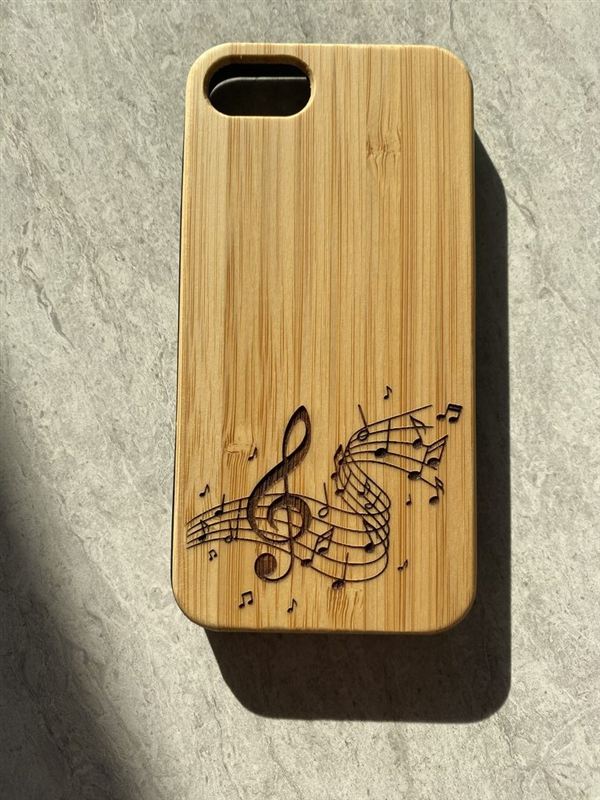 Étui de téléphone en bambou gravé d'une portée musicale